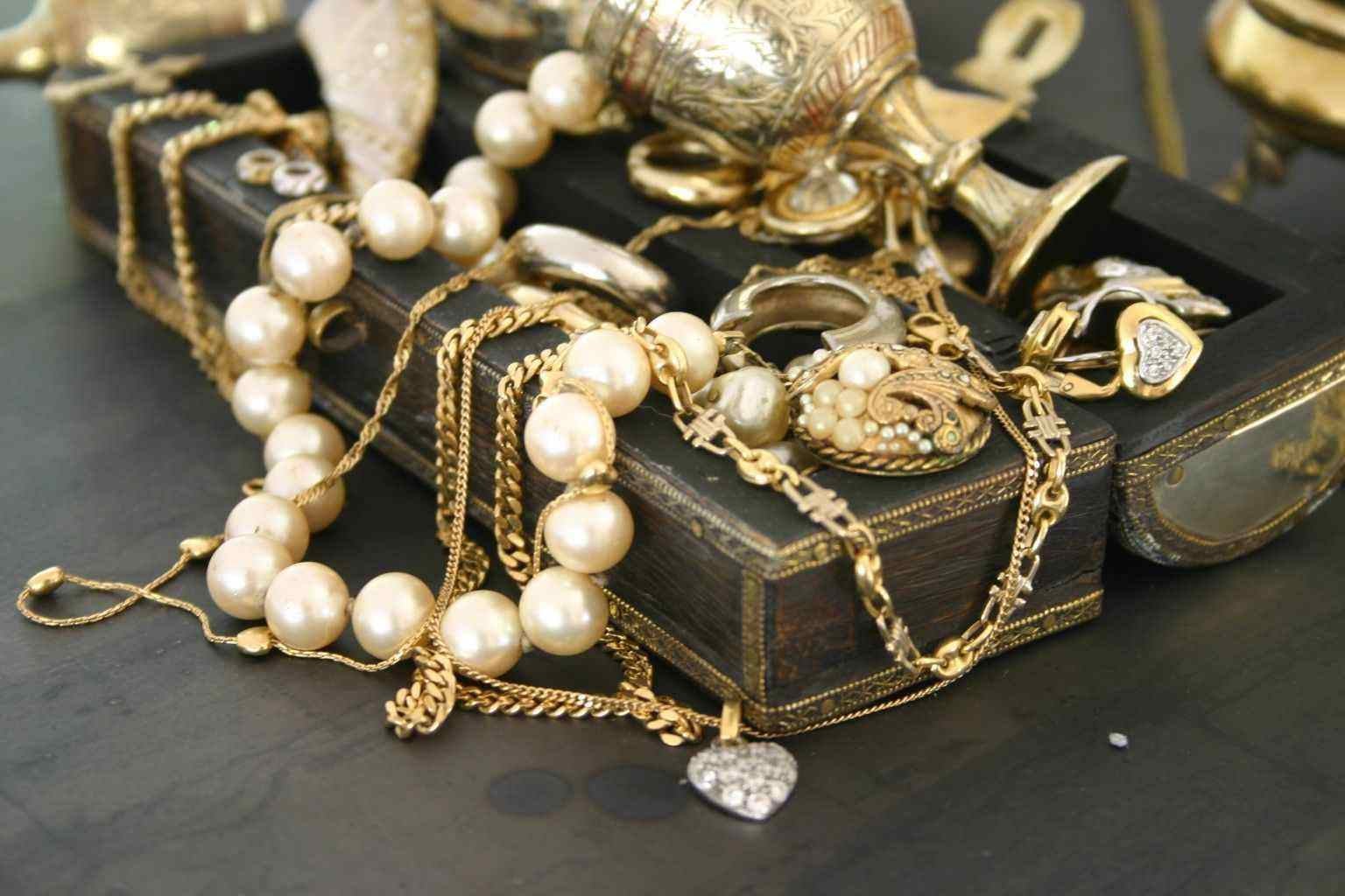 A display of gold jewelry and various items arranged on a table in Houston, TX.